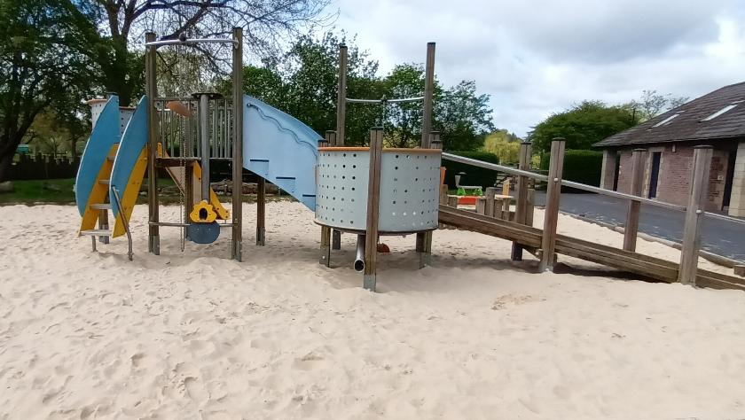REC ground play area sand pit and play equipment, with a slide