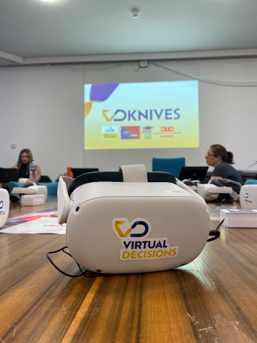 virtual reality goggles on table with projector background that reads VR knife crime prevention