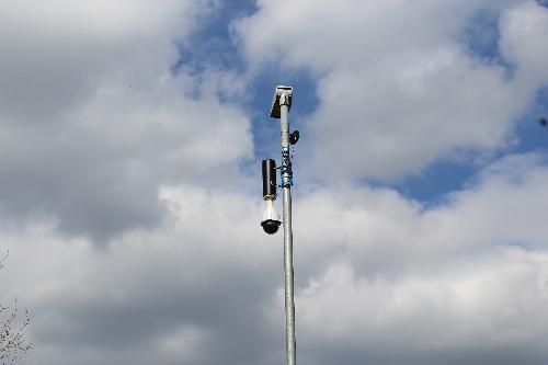 CCTV camera with blue sky and clouds in the background